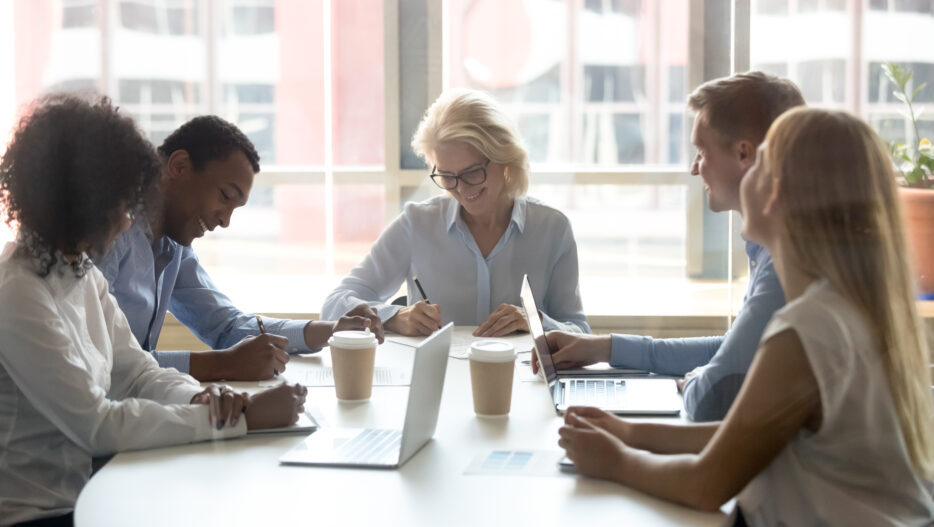 Diverse business partners sign two contracts at group meeting, businessman and businesswoman deal parties write signature on papers after successful negotiation make partnership agreement with client